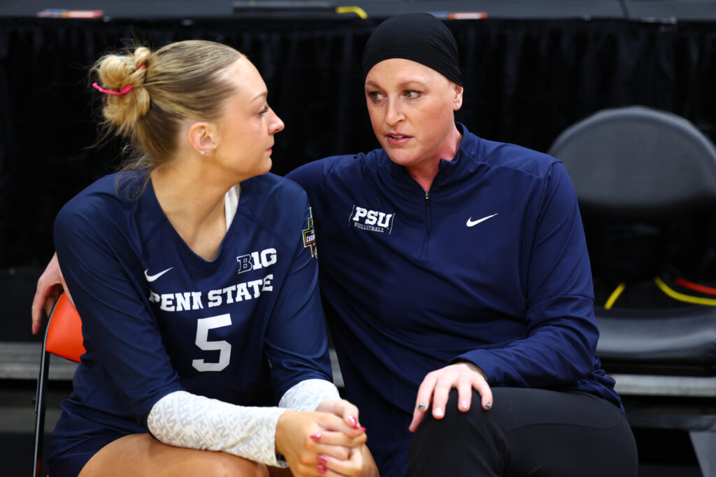 Penn State volleyball head coach Katie Schumacher-Cawley coaches player Jordan Hopp on the sideline during the 2024 NCAA semifinals.