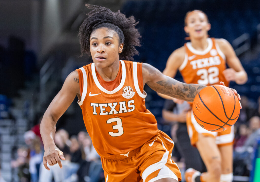 Texas star Rori Harmon dribbles up the court during an NCAA basketball game.